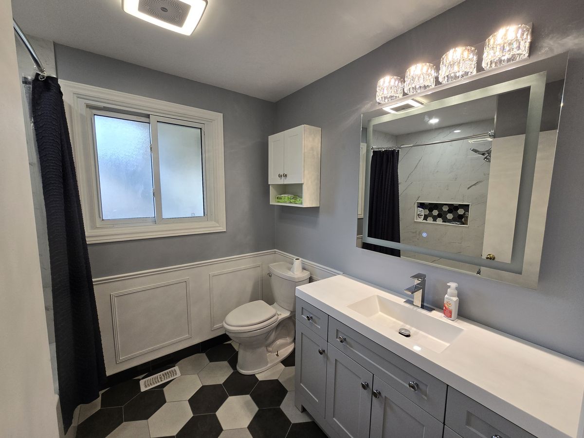 Renovated bathroom with custom vanity and hex tile
